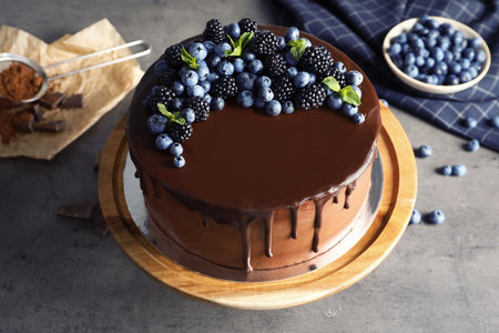 Fresh delicious homemade chocolate cake with berries on gray tableの写真素材