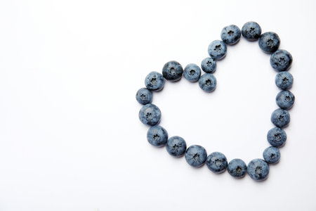 Flat lay composition with tasty blueberry and space for text on white backgroundの写真素材