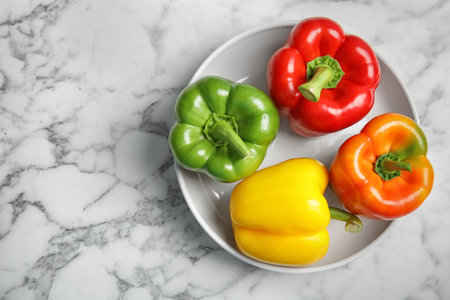 Bowl with ripe paprika peppers on table, top viewの写真素材