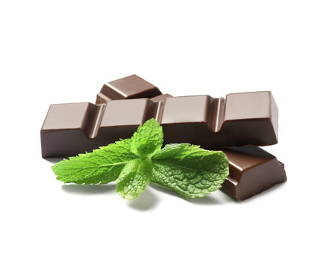 Pieces of dark chocolate with mint on white backgroundの写真素材