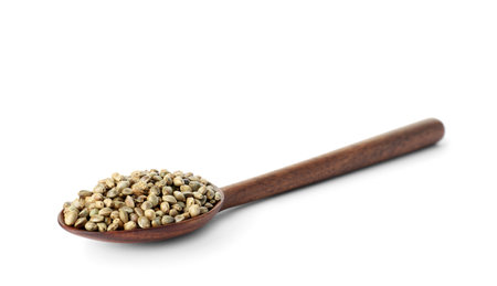 Spoon with hemp seeds on white backgroundの写真素材