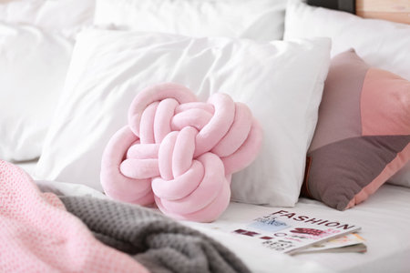Pillows and magazines on bed. Idea for interior designの写真素材