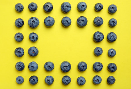 Flat lay composition with tasty blueberry and space for text on color backgroundの写真素材