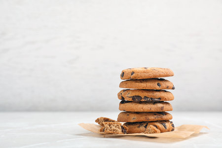 Stack of tasty chocolate cookies on light tableの写真素材