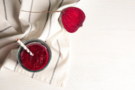 Glass of beet smoothie on white wooden background with space for text, top viewの写真素材