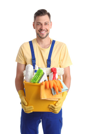 Male janitor with cleaning supplies on white backgroundの写真素材