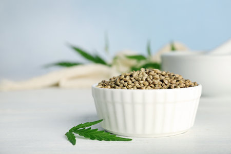 Ceramic bowl with hemp seeds on tableの写真素材