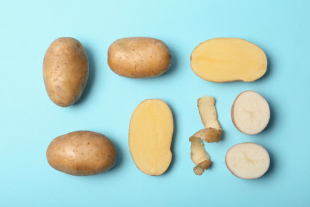 Flat lay composition with fresh ripe organic potatoes on color backgroundの写真素材