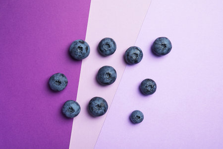 Flat lay composition with tasty blueberry on color backgroundの写真素材