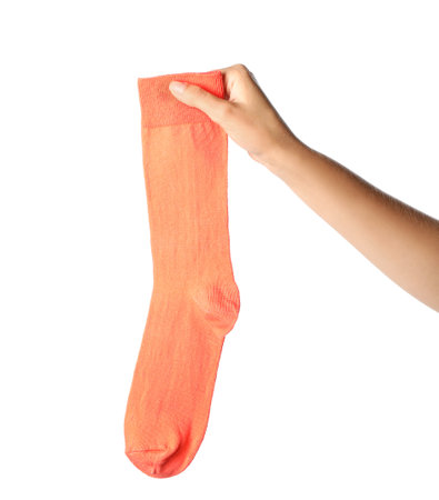 Woman holding colorful sock on white backgroundの写真素材