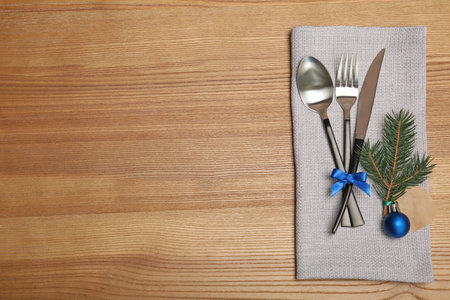 Cutlery and napkin on wooden background, top view. Table settingsの写真素材
