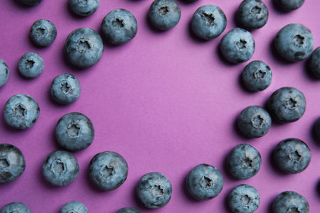 Flat lay composition with tasty blueberry and space for text on color backgroundの写真素材