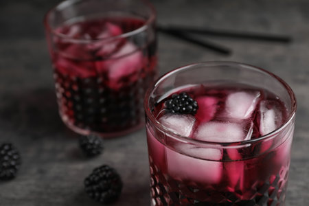 Glasses with iced blackberry lemonade on gray table, closeupの写真素材