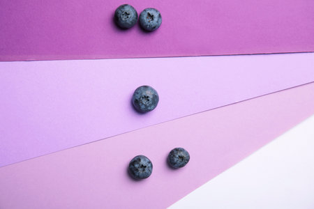 Flat lay composition with tasty blueberry on color background