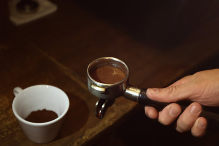 Barista preparing fresh aromatic coffee, closeup