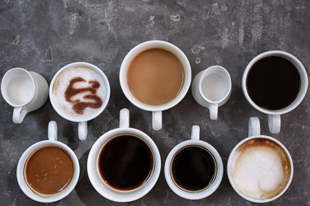 Cups of fresh aromatic coffee on gray background, top viewの写真素材
