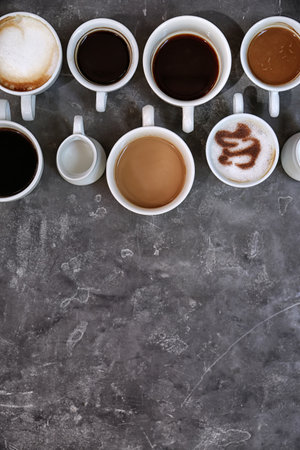 Cups of fresh aromatic coffee on gray background, top viewの写真素材