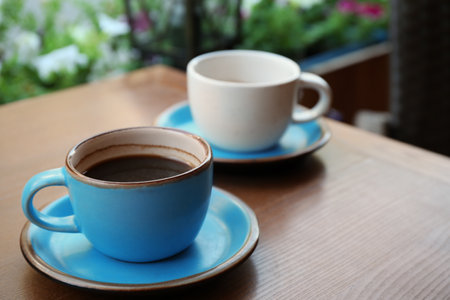 Cups of fresh aromatic coffee on wooden tableの写真素材