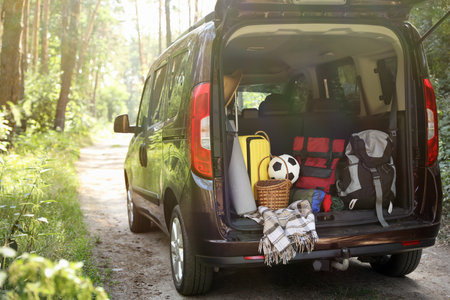 Van with camping equipment in trunk outdoorsの写真素材