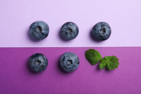 Flat lay composition with tasty blueberry on color backgroundの写真素材