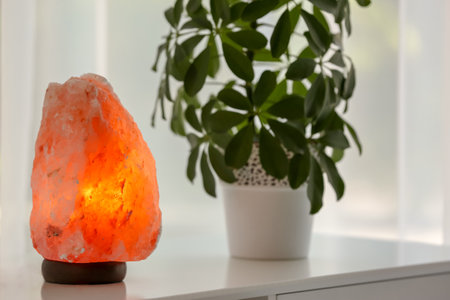 Exotic Himalayan salt lamp on table indoorsの写真素材