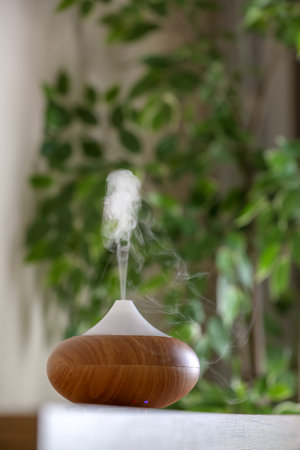 Aroma oil diffuser lamp on table against blurred backgroundの写真素材