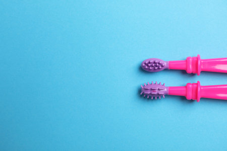 Manual toothbrushes for children on color background, top view with space for textの写真素材