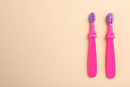 Manual toothbrushes for children on color background, top view with space for textの写真素材