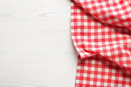 Checkered picnic tablecloth on wooden background, top viewの写真素材