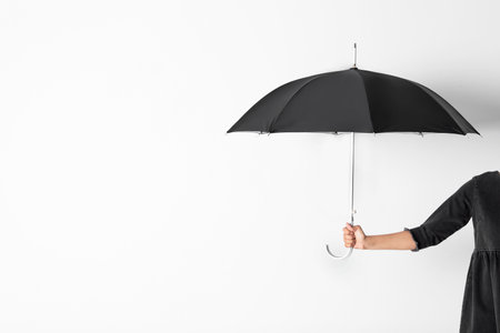 Person holding open umbrella on white background with space for designの写真素材
