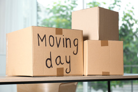 Cardboard boxes on table against blurred background. moving dayの写真素材