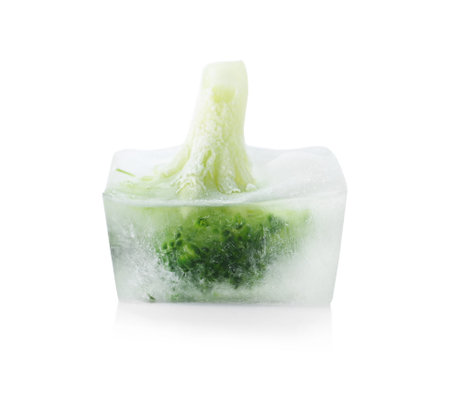 Fresh broccoli in ice cube on white background. frozen vegetablesの写真素材