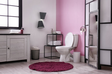 Toilet bowl in modern bathroom interior