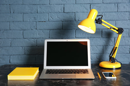 Laptop with blank screen on office table. Mock up designの写真素材
