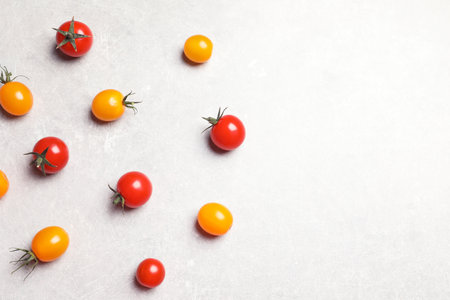 Flat lay composition with juicy tomatoes on gray backgroundの写真素材
