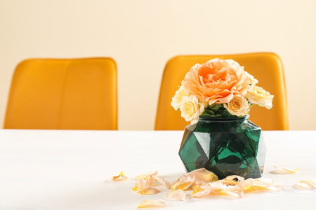 Vase with blooming flowers on table indoorsの写真素材