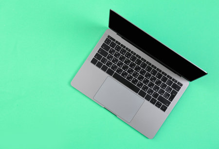 Modern laptop on color background, top viewの写真素材