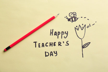 Pencil, text HAPPY TEACHER'S DAY and drawings on paperの写真素材