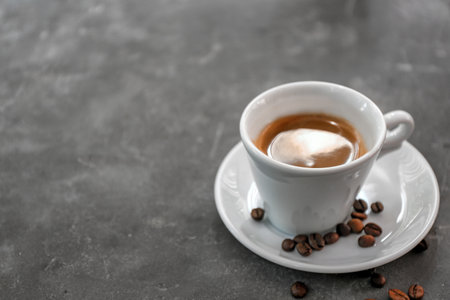 Cup of fresh aromatic coffee on gray backgroundの写真素材