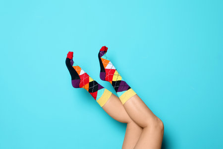 Woman wearing bright socks on color backgroundの写真素材