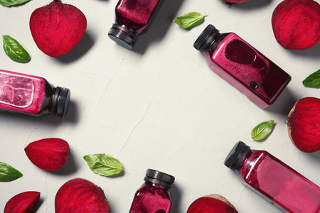 Flat lay composition with beet smoothies on light background. Space for textの写真素材