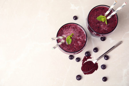 Glasses with delicious acai smoothie on table, top viewの写真素材