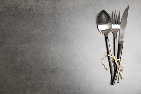 Silver cutlery on gray background, top view. Table settingsの写真素材