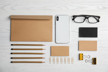 Flat lay composition with stationery on white wooden background. Mock up designの写真素材