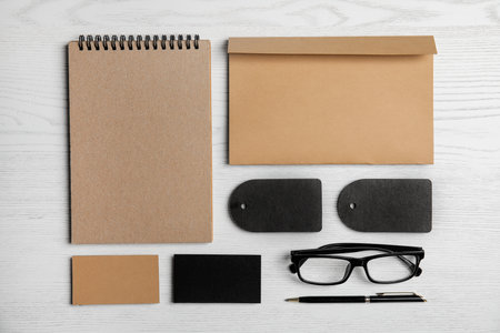 Flat lay composition with stationery on white wooden background. Mock up designの写真素材