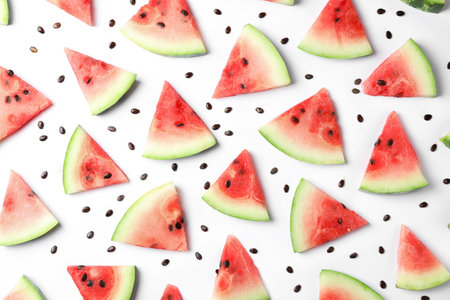 Flat lay composition with slices and seeds of watermelon on white backgroundの写真素材