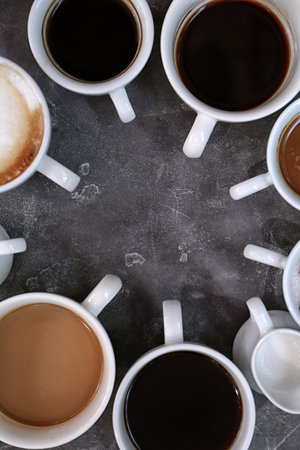 Cups of fresh aromatic coffee on gray background, top viewの写真素材