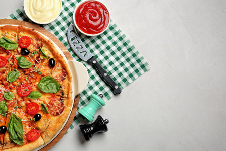 Flat lay composition with tasty homemade pizza and space for text on tableの写真素材