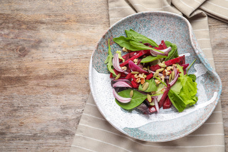 Plate with delicious beet salad on wooden background, top viewの写真素材