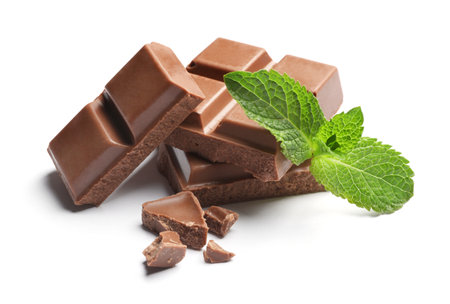 Pieces of milk chocolate with mint on white backgroundの写真素材